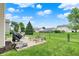 Well-maintained backyard featuring outdoor seating, a grill, and manicured lawn at 3811 Tartan Trl, Whitestown, IN 46075