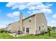 Exterior of the home showing the spacious backyard with patio furniture and well-maintained lawn at 3811 Tartan Trl, Whitestown, IN 46075