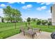 Inviting backyard with green lawn, privacy fence, and patio with lounge chairs at 3811 Tartan Trl, Whitestown, IN 46075