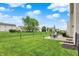 Spacious backyard featuring well-maintained lawn, black fencing, and a concrete patio area at 3811 Tartan Trl, Whitestown, IN 46075