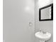 Clean and simple powder room featuring a pedestal sink and a sleek mirror at 3811 Tartan Trl, Whitestown, IN 46075