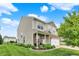 Exterior view of a two-story home, showcasing its vinyl siding, covered porch, and landscaped front yard at 3811 Tartan Trl, Whitestown, IN 46075