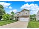 Two-story home featuring vinyl siding, brick accents, a well-maintained lawn, and a two-car garage at 3811 Tartan Trl, Whitestown, IN 46075