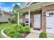Close-up of the front porch with brickwork, landscaping, and a white front door at 3811 Tartan Trl, Whitestown, IN 46075