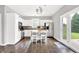 Bright, modern kitchen with white cabinets, stainless steel appliances, a kitchen island, and dark hardwood floors at 3811 Tartan Trl, Whitestown, IN 46075