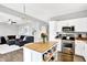 Modern kitchen featuring white cabinets, stainless steel appliances, and a center island with butcher block top at 3811 Tartan Trl, Whitestown, IN 46075