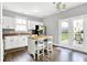 Kitchen with white cabinets, stainless steel appliances, an island with seating, and sliding glass doors at 3811 Tartan Trl, Whitestown, IN 46075