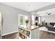 Open-concept kitchen with an island, connecting to a living room and featuring stainless steel appliances at 3811 Tartan Trl, Whitestown, IN 46075