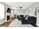 Comfortable living room featuring fireplace, ceiling fan, and a large sectional sofa at 3811 Tartan Trl, Whitestown, IN 46075