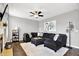 Cozy living room with fireplace, ceiling fan, and a comfortable sectional sofa at 3811 Tartan Trl, Whitestown, IN 46075