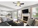 Bright living room with fireplace and large windows offering backyard view at 3811 Tartan Trl, Whitestown, IN 46075