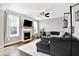 Bright living room featuring fireplace, ceiling fan, and a comfortable sectional sofa at 3811 Tartan Trl, Whitestown, IN 46075