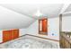 Finished attic room featuring built-in storage, sloped ceilings, and a large area rug at 402 E 4Th St, Sheridan, IN 46069