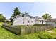 A fenced-in backyard featuring a two-story house, stairs, and green lawn at 402 E 4Th St, Sheridan, IN 46069
