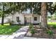 Charming single-story home with a well-maintained yard, mature tree, and inviting front entrance at 402 E 4Th St, Sheridan, IN 46069