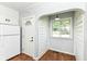 Hallway features an arch, a window, and access to an exterior door at 402 E 4Th St, Sheridan, IN 46069