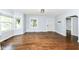 Spacious living room showcasing hardwood floors, natural light, and a convenient entry door at 402 E 4Th St, Sheridan, IN 46069