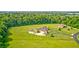 Stunning aerial view of estate featuring an expansive lawn, pool, and multiple outbuildings at 4181 Whitetail Woods Dr, Bargersville, IN 46106
