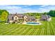 Majestic aerial view of sprawling property featuring a sparkling pool and meticulously maintained grounds at 4181 Whitetail Woods Dr, Bargersville, IN 46106