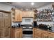 The finished basement bar features custom wood cabinets, granite countertops, and glass shelves for bottles and glassware at 4181 Whitetail Woods Dr, Bargersville, IN 46106