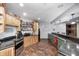 Finished basement bar area boasts custom wood cabinetry, granite counters, tile floors, and ample liquor storage at 4181 Whitetail Woods Dr, Bargersville, IN 46106