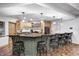Basement bar with wooden cabinets, a black countertop, and black barstools at 4181 Whitetail Woods Dr, Bargersville, IN 46106