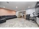 Spacious basement with recessed lights, tile floors, leather sofa, and glass doors to a game room at 4181 Whitetail Woods Dr, Bargersville, IN 46106