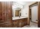 Bathroom boasts wood cabinets, sleek countertops, and modern fixtures at 4181 Whitetail Woods Dr, Bargersville, IN 46106