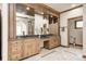 Elegant bathroom with dual sinks, a large mirror, and custom wood cabinets for a spa-like retreat at 4181 Whitetail Woods Dr, Bargersville, IN 46106