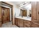 Bathroom boasts wood cabinets, sleek countertops, modern fixtures, and multiple doors at 4181 Whitetail Woods Dr, Bargersville, IN 46106