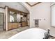 Luxurious bathroom offering wood cabinets, a double vanity, and a pristine soaking tub at 4181 Whitetail Woods Dr, Bargersville, IN 46106
