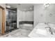 Spa-like bathroom with a glass shower, soaking tub, marble tile, and double vanity sinks at 4181 Whitetail Woods Dr, Bargersville, IN 46106