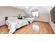 Bedroom features hardwood floors, two beds with patterned comforters, and a ceiling fan at 4181 Whitetail Woods Dr, Bargersville, IN 46106