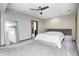 Primary bedroom featuring a tray ceiling, modern furniture, carpet, and a ceiling fan at 4181 Whitetail Woods Dr, Bargersville, IN 46106