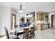 The dining room features a glass table with seating for six, along with wood cabinets and stainless refrigerator at 4181 Whitetail Woods Dr, Bargersville, IN 46106