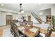 Spacious dining area showcases hardwood floors, a chandelier, and a staircase to the upper floor at 4181 Whitetail Woods Dr, Bargersville, IN 46106