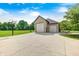 Spacious driveway leading to a three car garage on a lush green lawn, complemented by a basketball hoop at 4181 Whitetail Woods Dr, Bargersville, IN 46106