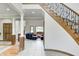 Elegant foyer features a staircase, tile flooring, and views into a luxurious living area at 4181 Whitetail Woods Dr, Bargersville, IN 46106
