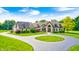 Charming two-story stone home features a circular drive, lush lawn and beautiful, mature landscaping at 4181 Whitetail Woods Dr, Bargersville, IN 46106
