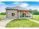A single story brick house with a covered porch, green lawn, and trimmed bushes at 4181 Whitetail Woods Dr, Bargersville, IN 46106