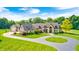 Stunning home with lush landscaping, circular driveway, and beautiful architectural details at 4181 Whitetail Woods Dr, Bargersville, IN 46106