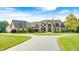 Beautiful home exterior with manicured lawn, mature trees, and a grand entrance at 4181 Whitetail Woods Dr, Bargersville, IN 46106
