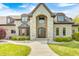 An elegant home with stone and brick, complemented by manicured shrubs and a winding walkway at 4181 Whitetail Woods Dr, Bargersville, IN 46106