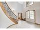 Welcoming foyer with elegant staircase, arched doorway, and bright natural light at 4181 Whitetail Woods Dr, Bargersville, IN 46106