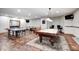 This game room boasts a pool table, ping pong table, and foosball table for endless entertainment at 4181 Whitetail Woods Dr, Bargersville, IN 46106