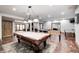 The game room boasts a pool table, ping pong table, and foosball table in an open concept layout at 4181 Whitetail Woods Dr, Bargersville, IN 46106