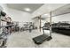 Spacious garage with concrete floors, gym equipment, and storage at 4181 Whitetail Woods Dr, Bargersville, IN 46106