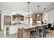 This gourmet kitchen features granite counters, custom cabinets and an eat-in bar with modern pendant lighting at 4181 Whitetail Woods Dr, Bargersville, IN 46106