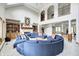 Expansive living room features high ceilings, fireplace, and a unique circular sofa design at 4181 Whitetail Woods Dr, Bargersville, IN 46106