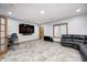 The room features a desk, tv, and leather sofa, great for relaxation and entertainment at 4181 Whitetail Woods Dr, Bargersville, IN 46106
